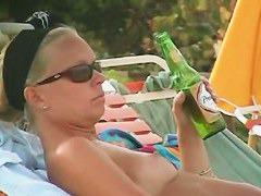 Hot video of a mature woman reading a book on a nudist beach