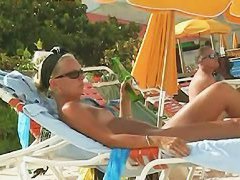 Hot video of a mature woman reading a book on a nudist beach