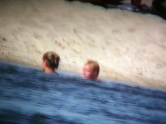 Porno of thin nude chicks on a nudist beach relaxing and talking