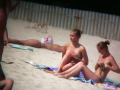Porno of thin nude chicks on a nudist beach relaxing and talking