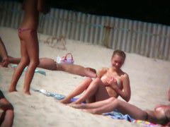Porno of thin nude chicks on a nudist beach relaxing and talking