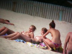 Porno of thin nude chicks on a nudist beach relaxing and talking
