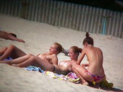 Porno of thin nude chicks on a nudist beach relaxing and talking