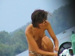 Topless sleek hotties on the nude beach getting filmed by a voyeur