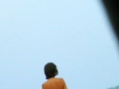 Topless sleek hotties on the nude beach getting filmed by a voyeur