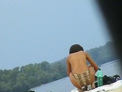 Topless sleek hotties on the nude beach getting filmed by a voyeur