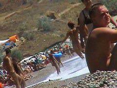Short-haired girl with trimmed pussy relaxing at the nudist beach