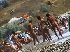 Short-haired girl with trimmed pussy relaxing at the nudist beach