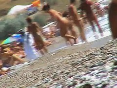 Short-haired girl with trimmed pussy relaxing at the nudist beach