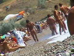 Short-haired girl with trimmed pussy relaxing at the nudist beach