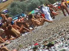 Short-haired girl with trimmed pussy relaxing at the nudist beach