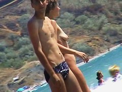 Short-haired girl with trimmed pussy relaxing at the nudist beach