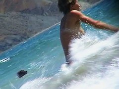 Short-haired girl with trimmed pussy relaxing at the nudist beach