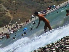 Short-haired girl with trimmed pussy relaxing at the nudist beach