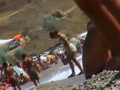 Short-haired girl with trimmed pussy relaxing at the nudist beach