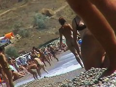 Short-haired girl with trimmed pussy relaxing at the nudist beach