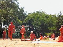 Candid camera rolling on an unsuspecting nudist beach