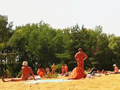 Candid camera rolling on an unsuspecting nudist beach