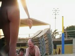 Attractive naked people on the street side nude beach tease each other
