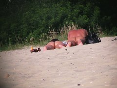 Hot couple of beach nudists voyeured on spycam from behind