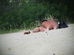 Hot couple of beach nudists voyeured on spycam from behind
