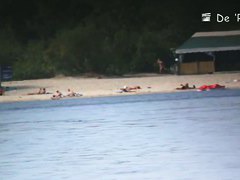 two babes on the beach playing with each other in the sea