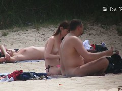 Nudist girl is topless while her partner is absolutely nude