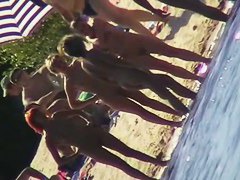 Nude beach filled with hot babes and an unsuspicious voyeur