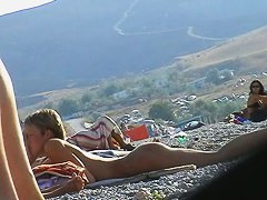 Several sexy nude girls caught on a beach with a spy cam