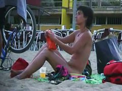 Short haired sweetie filmed on a nudist beach