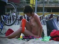 Short haired sweetie filmed on a nudist beach