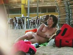Short haired sweetie filmed on a nudist beach