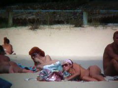 Perky breasted sweetie with a full bush followed on a nudist beach
