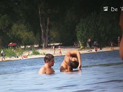 Beach nudist couple having sex in water on voyeur cam