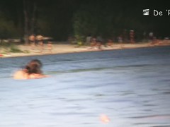 Beach nudist couple having sex in water on voyeur cam