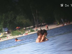 Beach nudist couple having sex in water on voyeur cam