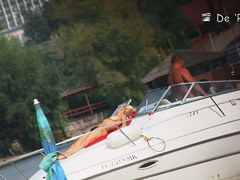 Beach nudist couple having sex in water on voyeur cam