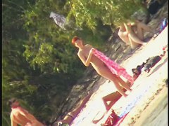 A horny voyeur loves filming hot nudity on the beach.