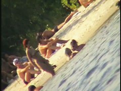 A horny voyeur loves filming hot nudity on the beach.
