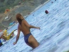Fat ass big boobed woman is swimming at the summer beach