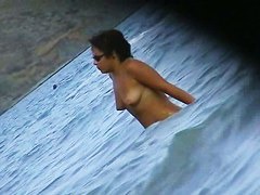 Fat ass big boobed woman is swimming at the summer beach