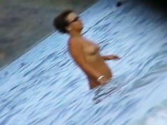 Fat ass big boobed woman is swimming at the summer beach