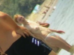 Beach voyeur hunting attractive nudist cooling in the sea
