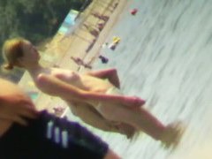 Beach voyeur hunting attractive nudist cooling in the sea