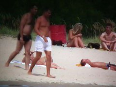 Busty blonde nude beach MILF spied on by a voyeur