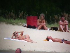 Busty blonde nude beach MILF spied on by a voyeur