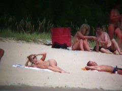 Busty blonde nude beach MILF spied on by a voyeur