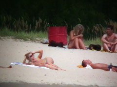 Busty blonde nude beach MILF spied on by a voyeur