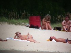 Busty blonde nude beach MILF spied on by a voyeur