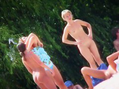 A group of girls showing off their naked bodies at the beach